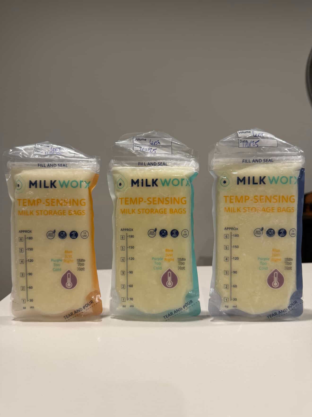 Three packages of MilkWorx temp-sensing milk storage bags on a white surface.